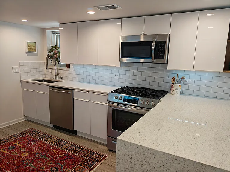 Kitchen includes new refrigerator, full-size dishwasher and stove/oven, and microwave.