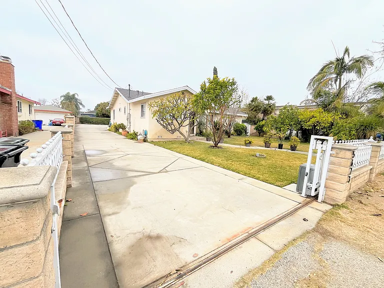 Gated driveway to parking spot.
Main house in front.