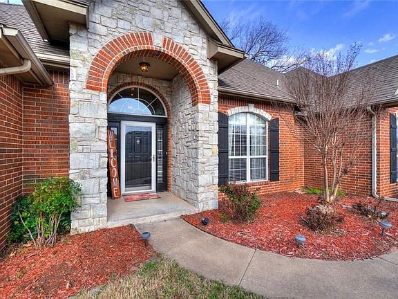 Front door with landscaping.