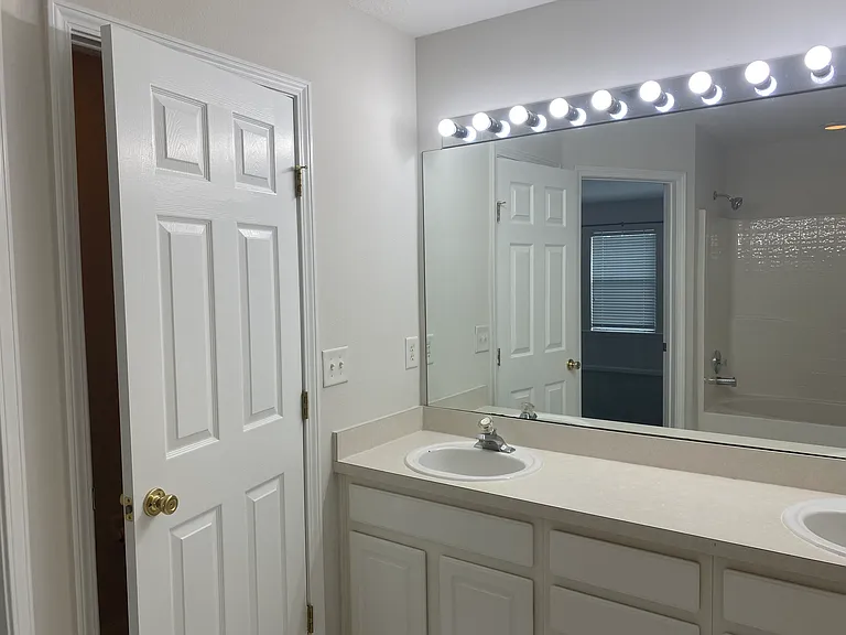 Master bathroom with dual sinks, private toilet