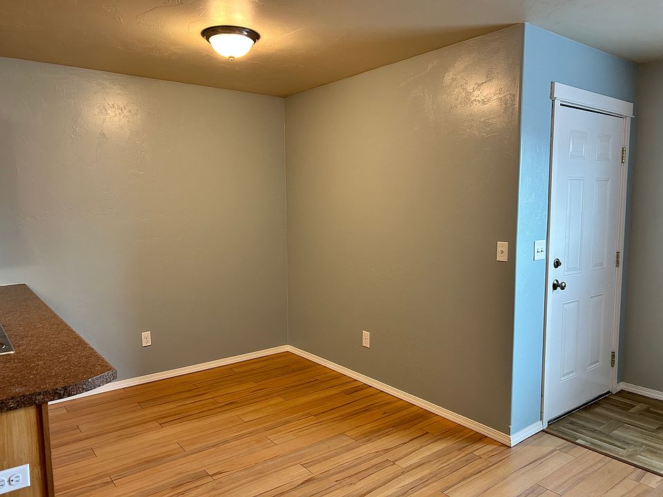 Dining area (next to the living room and kitchen). Front door pictured.
