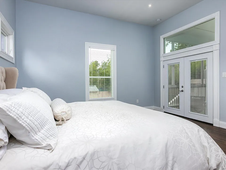 Master bedroom has high ceilings and has a private entrance through the screened porch. Plenty of room for a king bed or two twins plus 2 desks.