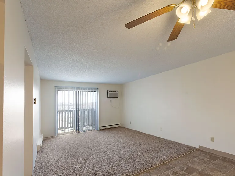 Living with balcony and wall unit air conditioning