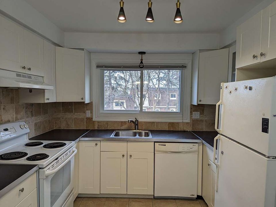 U Shaped Kitchen provides tons of storage, food prep area, fridge, stove, and dishwasher.