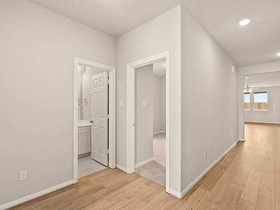 The entryway welcomes you to two bedrooms and a hallway leading to the open concept living space.