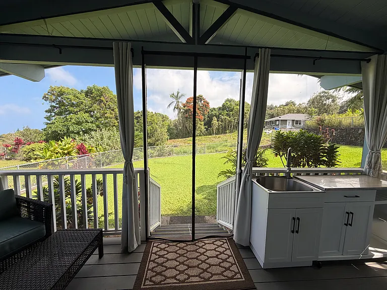 View of screened lanai looking out to fenced backyard
