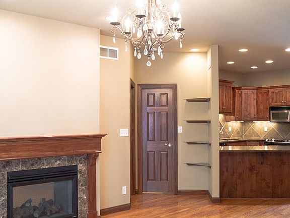 Looking from living room to fireplace and kitchen