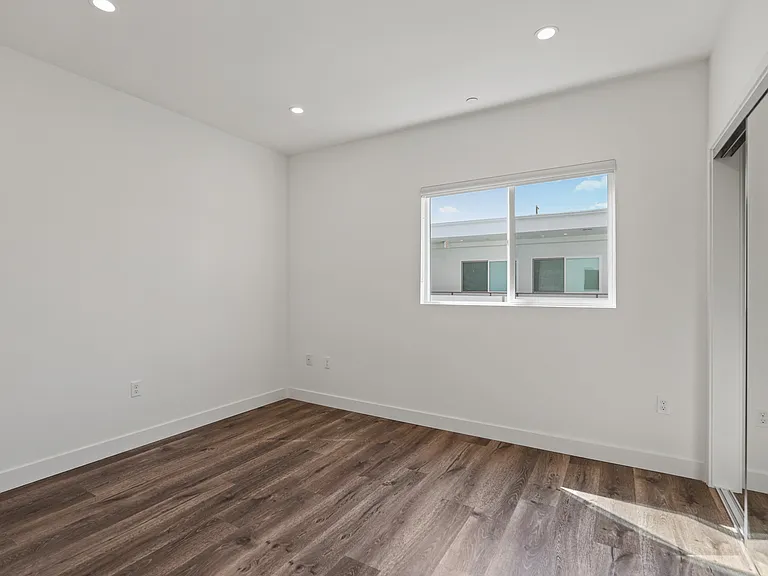 Bedroom with Recessed Lighting, Mirrored Closet, Vinyl Flooring, and Window
