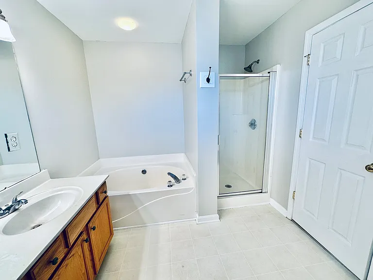 Master bath with garden tub and glass shower.