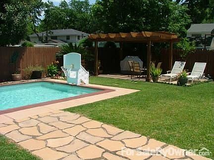 Back of House : View from the french doors. Large pergola covers a concrete slab.