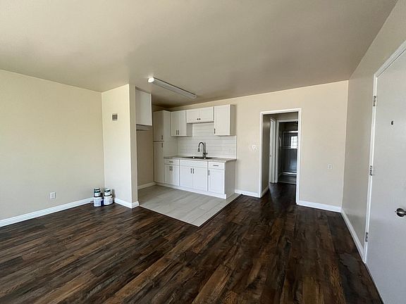 living room, kitchen and entry door, hallway to bathroom and bedroom