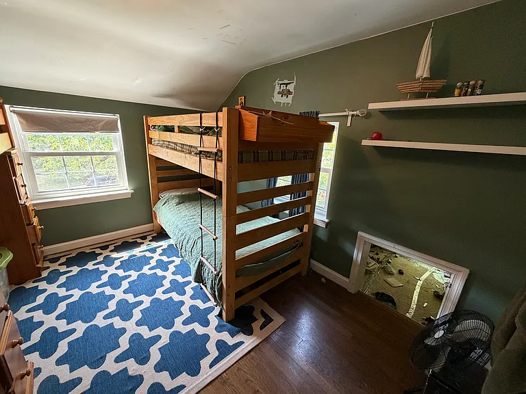 Upstairs medium bedroom w/adjoining crawl space.