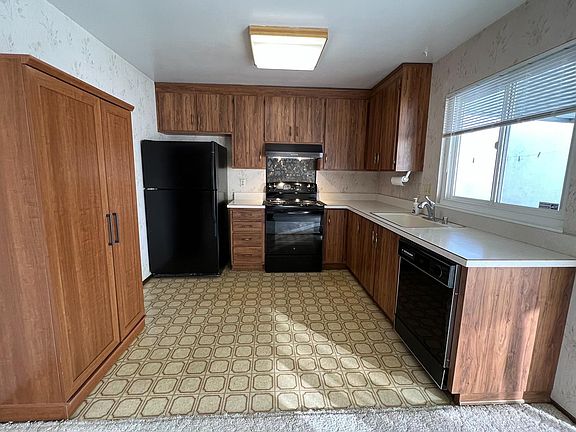 Kitchen with brand new electric range and new exhaust hood.