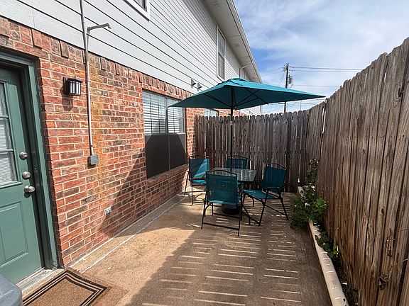 Back patio includes table, chairs & umbrella for a more relaxing atmosphere!