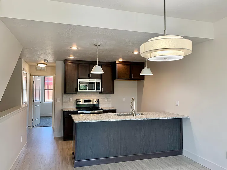 Kitchen with plenty of barstool seating, dining area pantry, full bath in hallway and large bedroom with built in AC and Heat