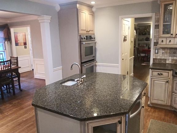 Kitchen crown molding and double wall ovens. Dishwasher in island.