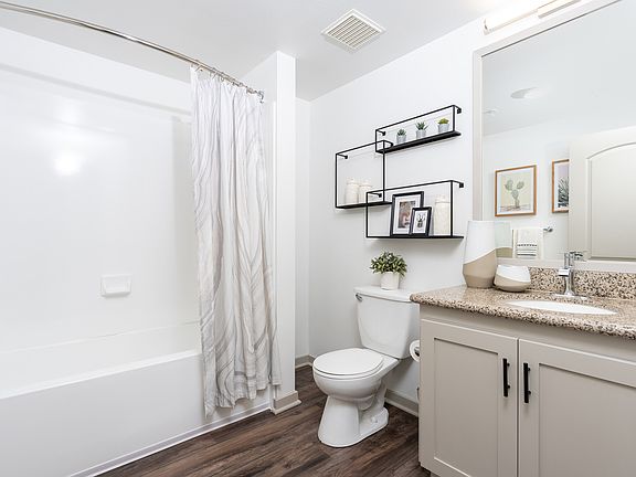 Renovated bathrooms include new lighting, faucet, and hardware