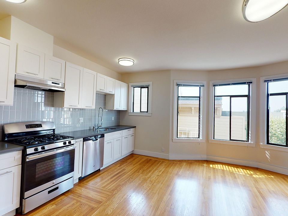 Living area that features cabinets, stove, range hood, and sink