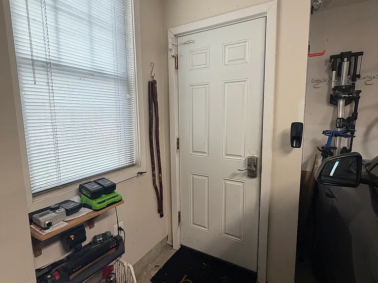 You enter through the back gate and use your code to enter the garage and another code to go up the stairs