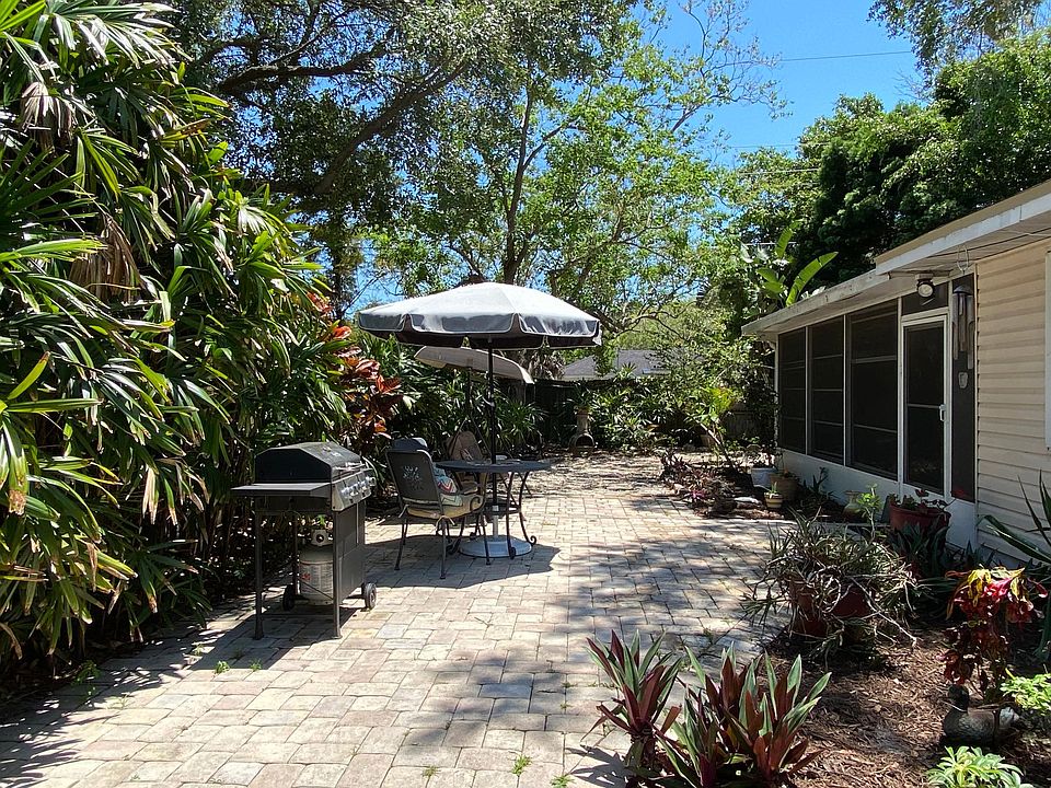 Patio with fenced in back yard, BBQ and swing
