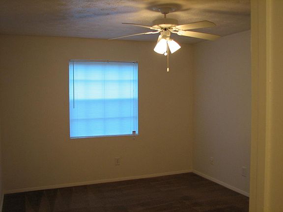 Master bedroom with walk in closet and ceiling fan