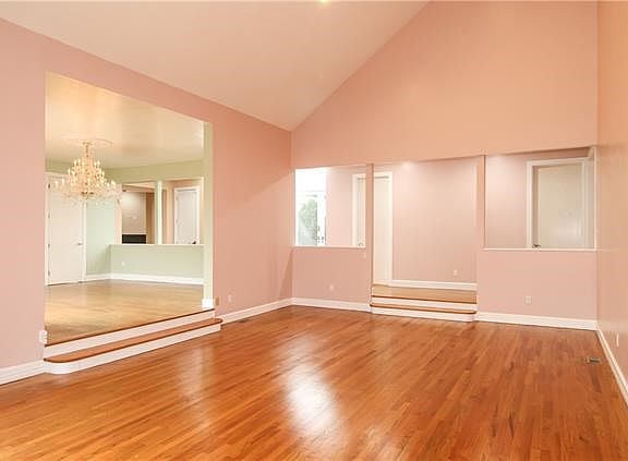 Living room with hardwood floors and vaulted ceiling