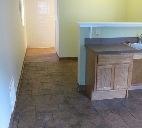 From living area, sleeping space behind half-wall, bathroom in back. Handicapped accessible.