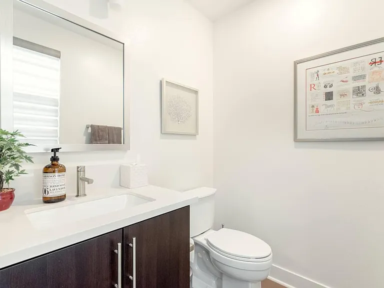 Half bathroom located on the top floor allowing easy access to the kitchen and living room areas.