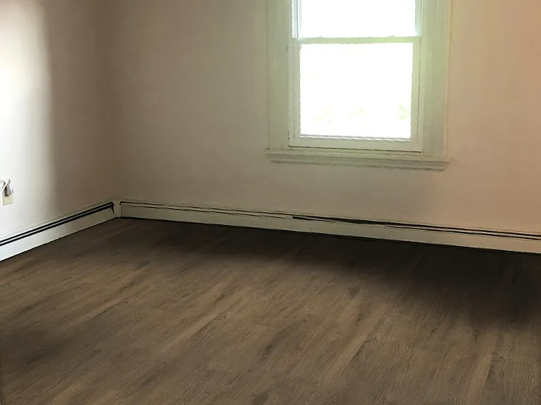 Large living room with closet, high ceilings, and great natural light.