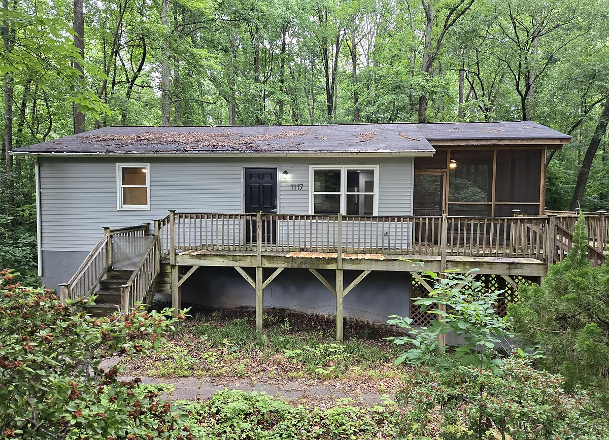 This home is nestled in a wooded lot, offering privacy and a natural retreat right in the heart of Cary. The spacious backyard backs up to serene woods, yet you're just minutes from Downtown Cary, shopping, and I-40. - 1117 Ralph Dr