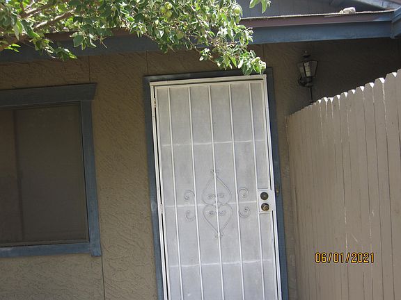 FRONT ENTRANCE WITH METAL SCREEN DOOR AND SHADE SCREEN