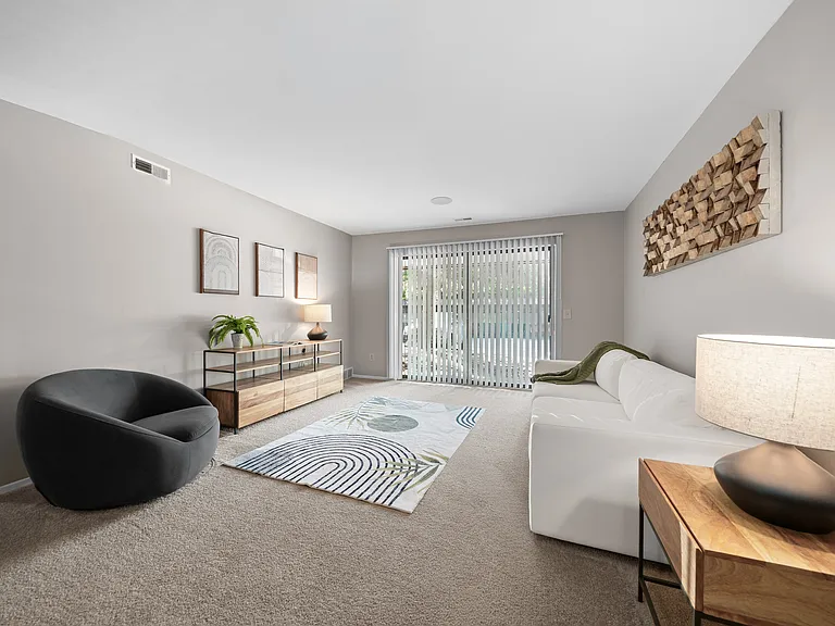 Spacious Living Room with Sliding Glass Door at Lakeside Village Apartments Clinton Township MI