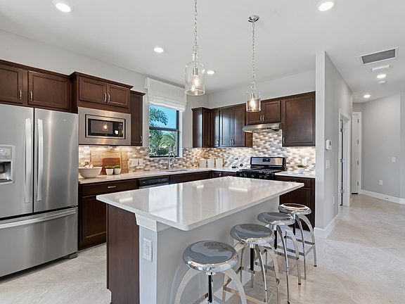 Gourmet kitchen with large center island and stainless steel appliances
