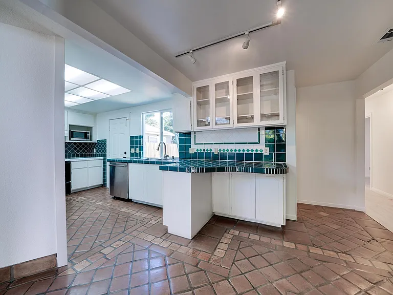 View entering front door. Entry room with view of kitchen, hallway, living room to the left.