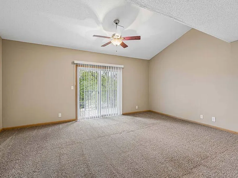 A bright, open living space with vaulted ceilings and direct access to your private outdoor retreat creates the perfect setting to relax and feel at home.