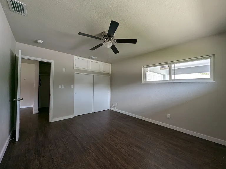 Large bedroom with wide closet and additional storage above