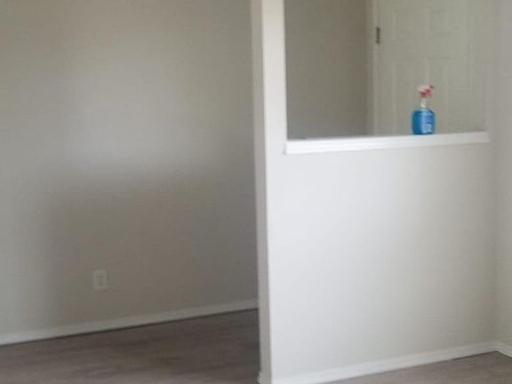 Standing in living room looking toward front door.