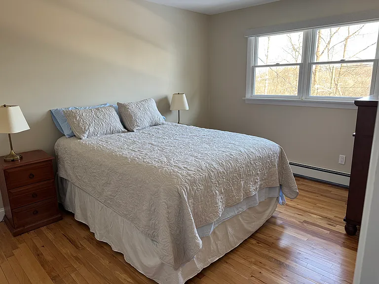 This bedroom is furnished with a queen sized bed, two night stands, two lamps, one large dresser, one walk in closet. It is 13' x 10' - 130 sq. ft.