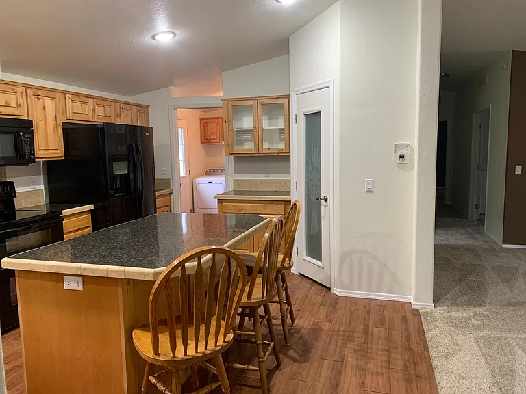 enter the laundry room from the large kitchen and exit out the side door to covered parking.