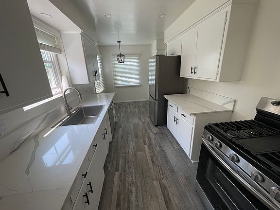 Bright kitchen with granite counters and all the essentials