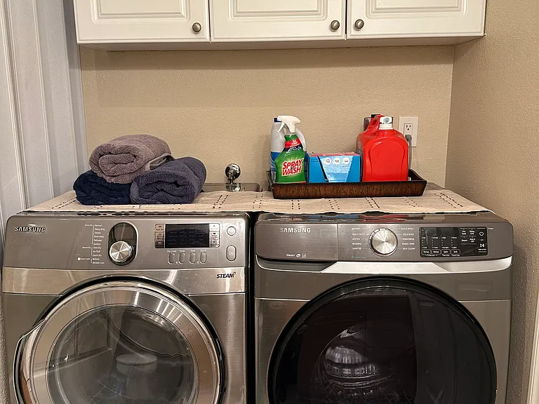 Laundry days are made easier with a washer & dryer in this nook