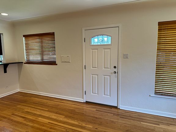 Living room has hardwood floors and coved ceilings