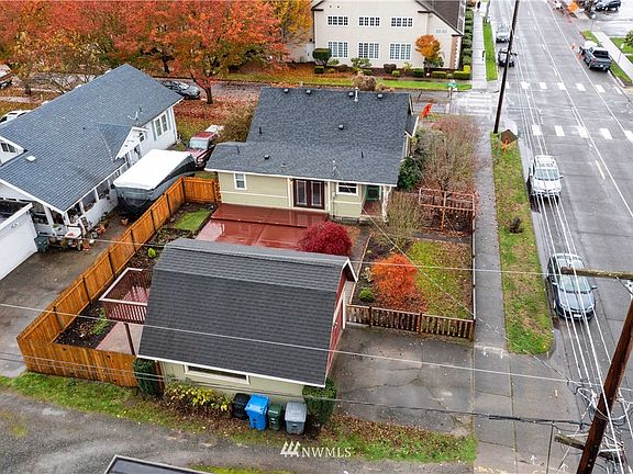 Great corner lot offers space for entertaining, gardening and parking~2 car detached garage~Fully fenced backyard