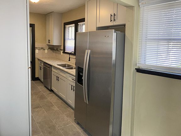 Brand new kitchen with soft-close cabinets, granite countertops, and a full whirlpool stainless appliance suite.