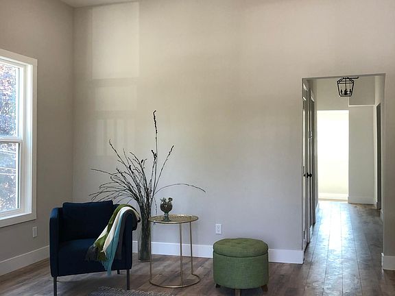 10 foot ceiling, spacious living room with ample natural light through two 5.5 foot tall windows. Wood laminate flooring in living room, both bedrooms, hall and sunroom. All new textured walls, doors, dual pane windows. Decorator two tone paint.