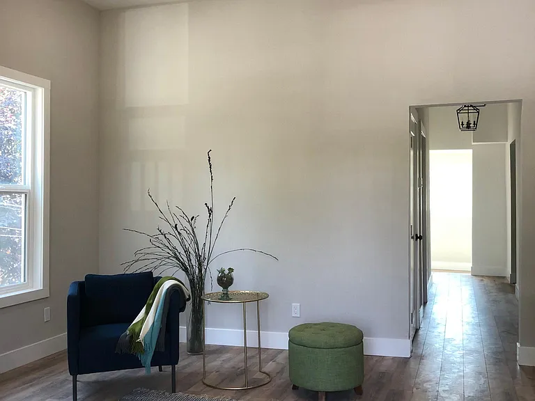 10 foot ceiling, spacious living room with ample natural light through two 5.5 foot tall windows. Wood laminate flooring in living room, both bedrooms, hall and sunroom. All new textured walls, doors, dual pane windows. Decorator two tone paint.