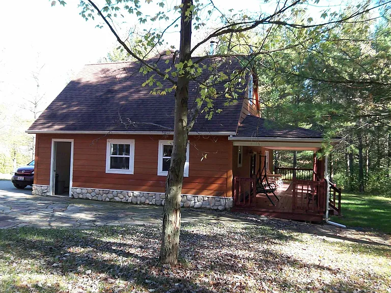 Side view of garage with deck on the rear.
