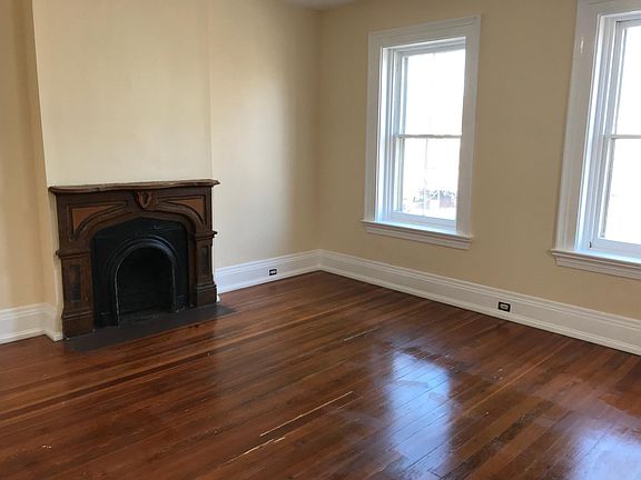 Living room. Original windows look out onto 6th street promenade.