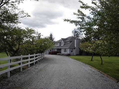 Flowering cherry trees line the the long private driveway
