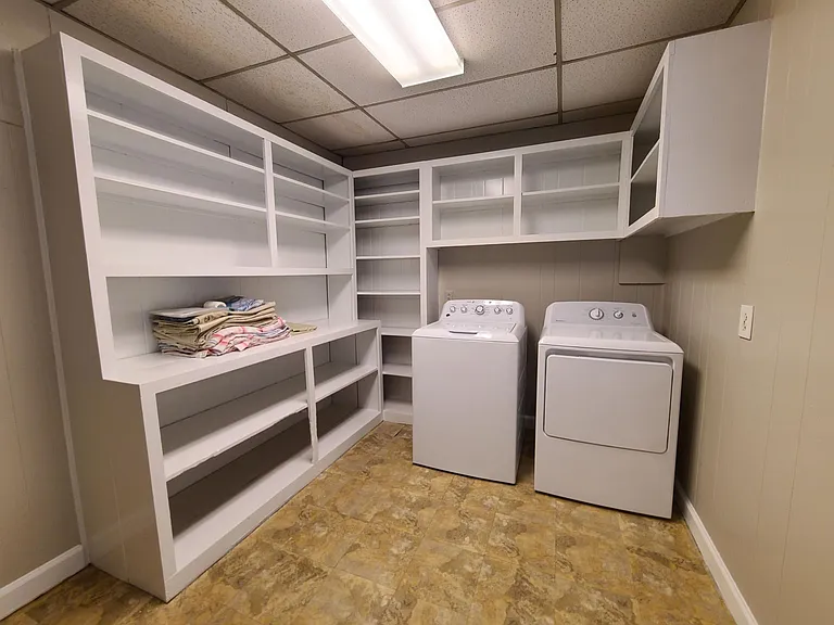 Enormous laundry room with loads of storage and shelving. Washer & dryer are included.
